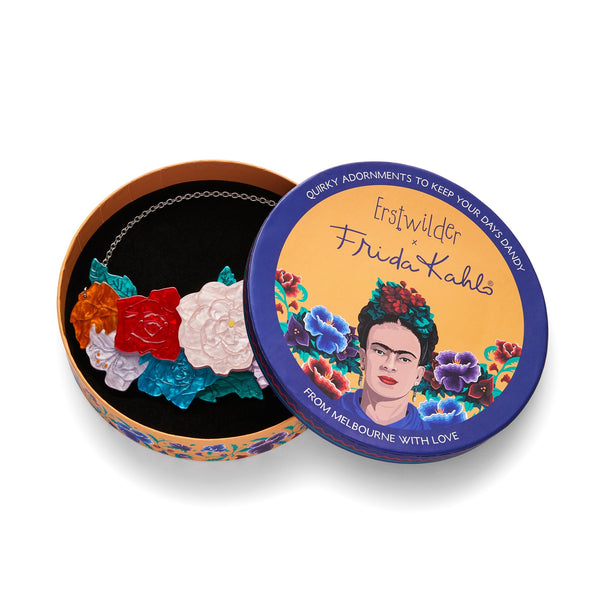 Frida Kahlo Collection “Declaración Floral” layered resin pendant necklace, comprised of white, yellow, red, orange, blue, and lavender assorted flowers and green leaves on silver metal link chain, shown in illustrated round box packaging