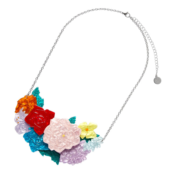 Frida Kahlo Collection “Declaración Floral” layered resin pendant necklace, comprised of white, yellow, red, orange, blue, and lavender assorted flowers and green leaves on silver metal link chain