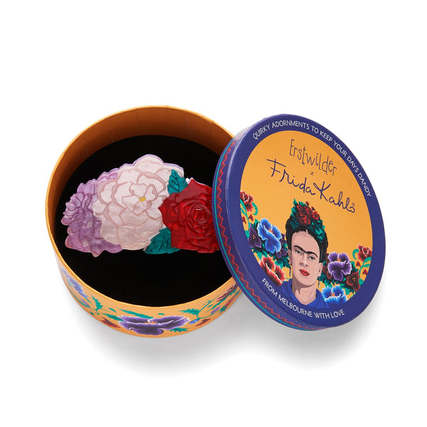 Frida Kahlo Collection “Declaración Floral” layered resin claw hair clip in red, pink, and lavender, shown in illustrated round box packaging