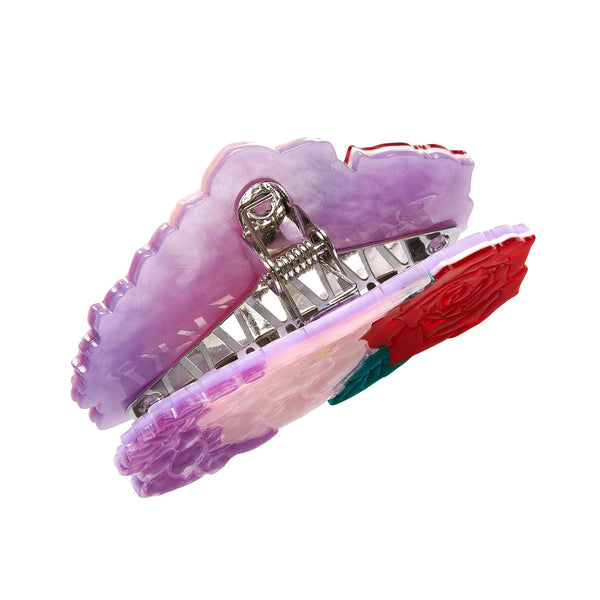 Frida Kahlo Collection “Declaración Floral” layered resin claw hair clip in red, pink, and lavender, shown from above with silver metal claw hardware in view