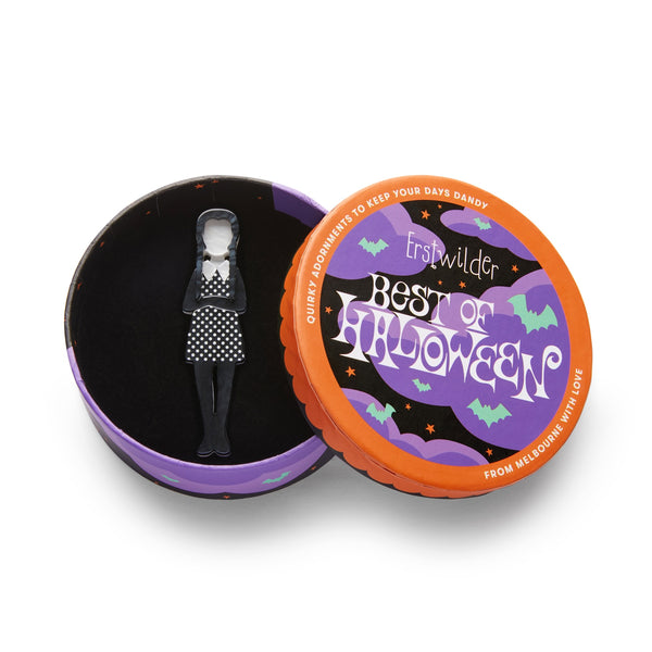 Best of Halloween collection Wednesday Addams-inspired girl in a in a black and white polka dot dress "Full of Woe" layered acrylic resin brooch, shown in illustrated round box packaging