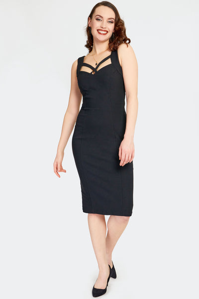 a model wearing a black bengaline sleeveless wiggle dress with vertical seaming, a sweetheart neckline, and crossed strap detailing in the front. Shown from the front