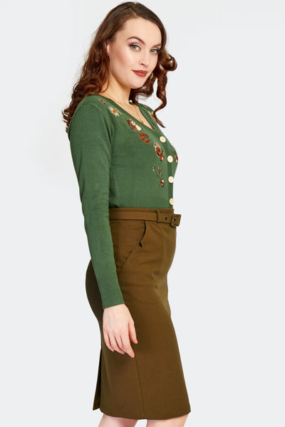 a model wearing a warm brown knit high-waisted pencil skirt with a self fabric belt and front pockets with notch details. Shown from the side