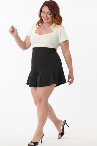 Black lightweight woven high-waist flared silhouette shorts with pin-tuck detail and black button-up side closure, shown on plus sizes model from side