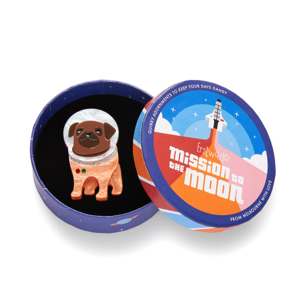 Mission to the Moon Collection "Interplanetary Pug” layered resin cosmonaut canine brooch, shown in illustrated round box packaging