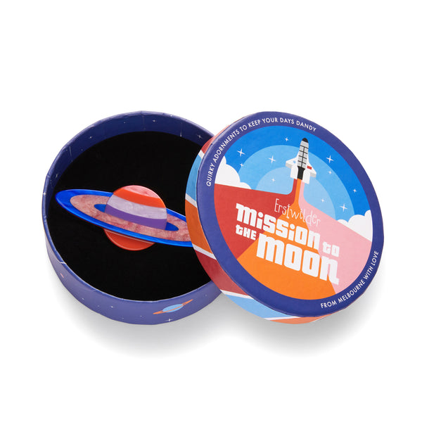 Mission to the Moon Collection "Sixth From the Sun” layered resin Saturn brooch, shown in illustrated round box packaging