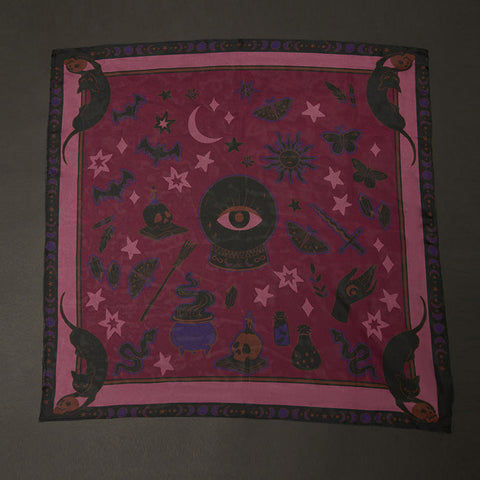 Purple fabric with black witchcraft-themed designs on a dark background