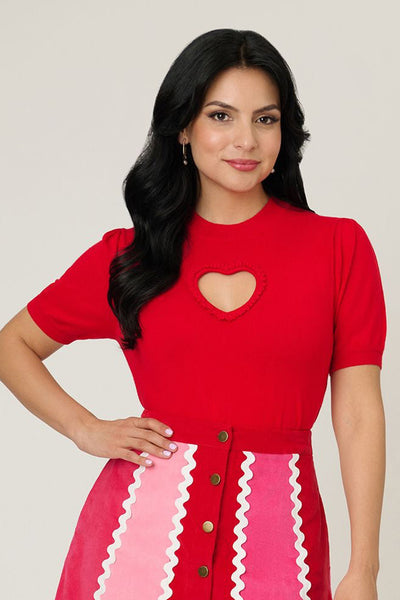 Bright red short sleeve sweater featuring heart-shaped keyhole cutout at bust, shown on a model