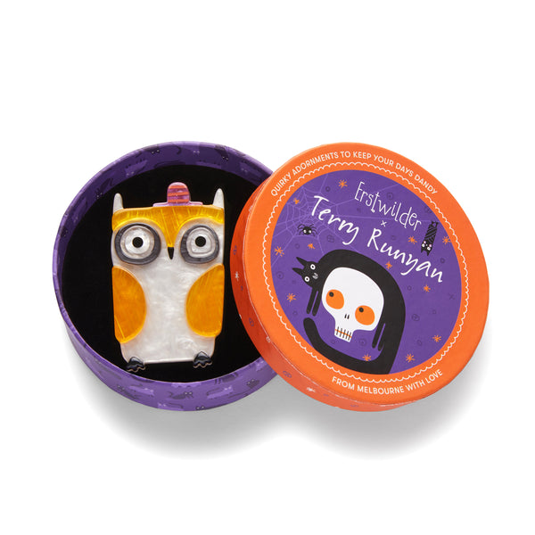 "Owl-O-Ween" layered resin owl in a purple & orange striped hat brooch, shown in illustrated round box packaging