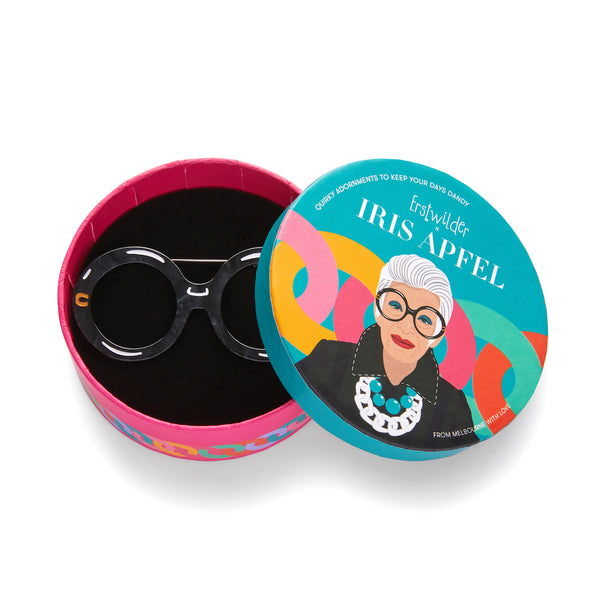 Iris Apfel x Erstwilder collaboration collection "I Wear Eyewear Iris" layered acrylic resin pair of black round frame spectacles brooch, shown in illustrated round box packaging