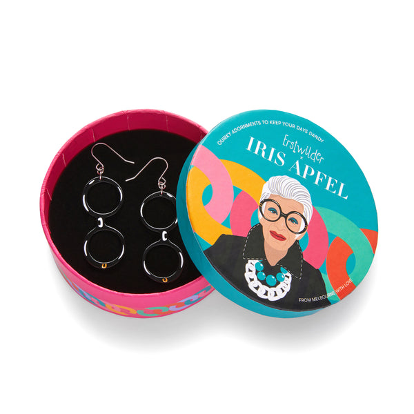 Iris Apfel x Erstwilder collaboration collection "Spectacular Spectacles Iris" layered acrylic resin pair of black round frame glasses dangle earings, shown in illustrated round box packaging