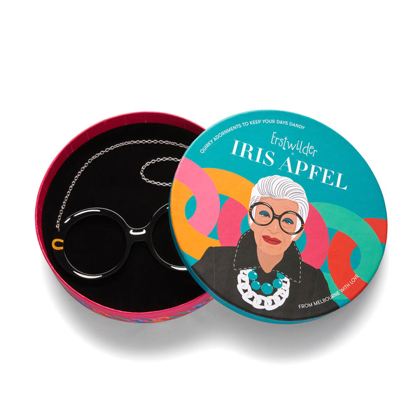 Iris Apfel x Erstwilder collaboration collection "Spectacular Spectacles Iris" acrylic resin pair of round frame glasses pendant necklace, shown in illustrated round box packaging