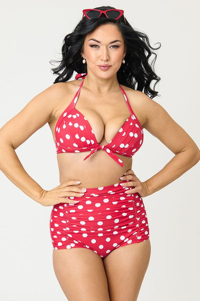 Bright red and polka dot patterned 50s style high-waist ruched front swim bottoms, shown on model from front