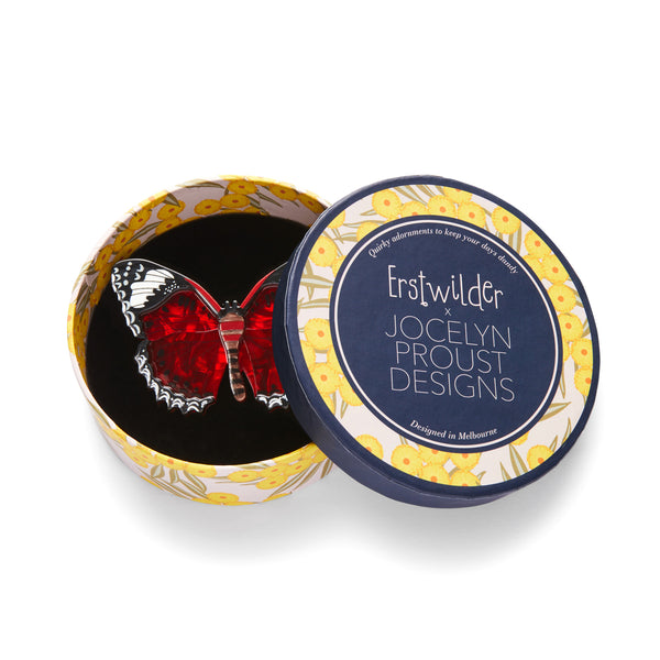 Jocelyn Proust Collaboration Collection "Wings Laced in Red" layered resin butterfly brooch, shown in illustrated round box packaging