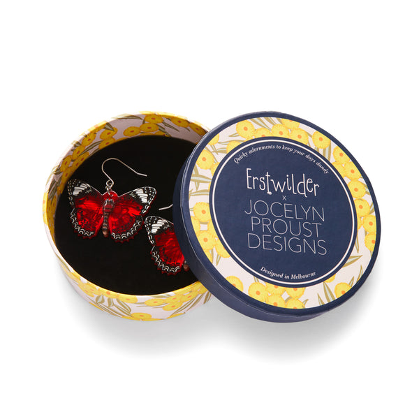 Jocelyn Proust Collaboration Collection "Wings Laced in Red" layered resin butterfly dangle earrings, shown in illustrated round box packaging