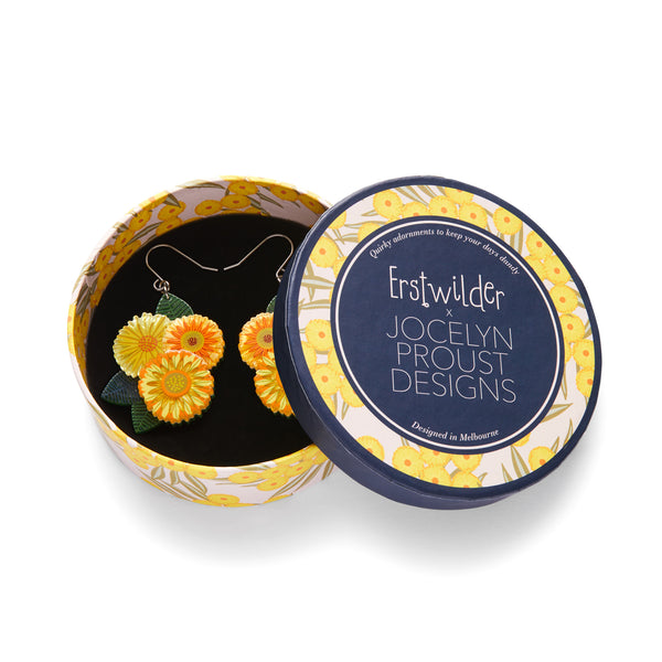 pair of Jocelyn Proust Collaboration Collection "Forever and Ever" layered resin trio of yellow blooms dangle earrings, shown in illustrated round box packaging
