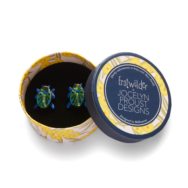 Jocelyn Proust Collaboration Collection "Luck of the Beetle" layered resin post earrings, shown in illustrated round box packaging