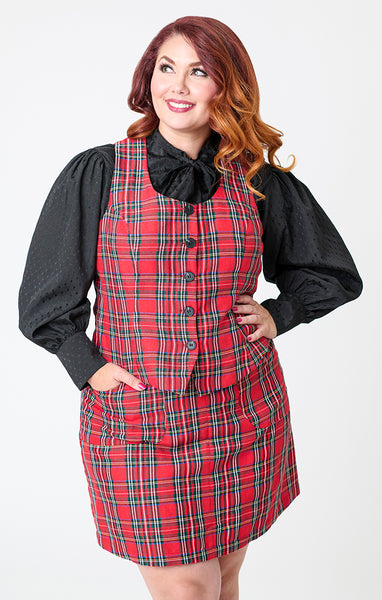 plus size model wearing a red plaid vest with vertical seaming, a round neckline, and black button closure. Shown layered with black blouse from front