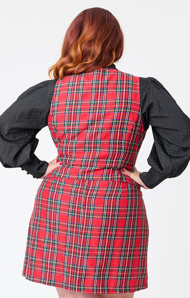 model wearing a red plaid vest with vertical seaming, a round neckline, and black button closure. Shown layered with black blouse from back