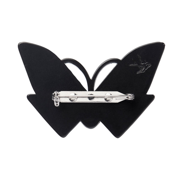 Untamed Elegance Collection "Butterfly Sonata" blue, pink, black, white, and mirror finish silver layered resin brooch depicting an Art Deco style butterfly as a mask on a lady's face, showing solid black back view