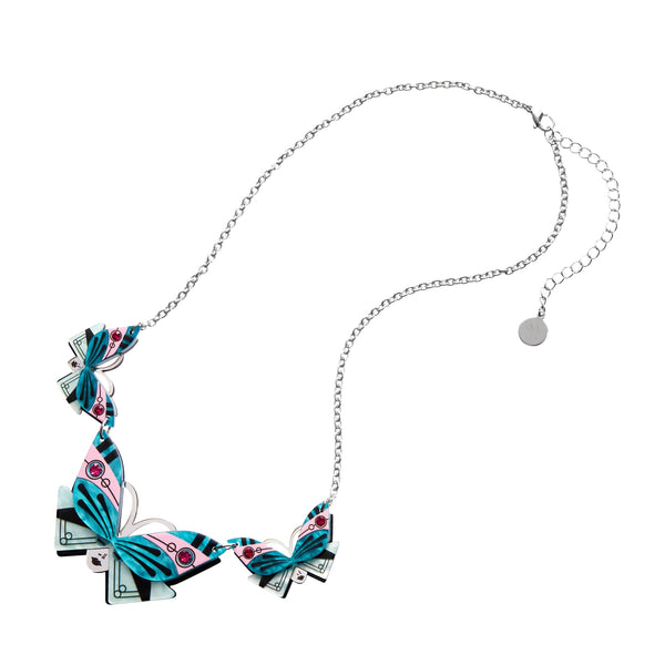 Untamed Elegance Collection "Butterfly Sonata" blue, pink, black, white, and mirror finish silver layered resin statement necklace with pink jewel accents consisting of three linked pendants depicting an Art Deco style butterfly as a mask on a lady's face on a shiny silver metal link chain