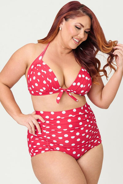 Bright red and polka dot patterned 50s style high-waist ruched front swim bottoms, shown on plus size model from front