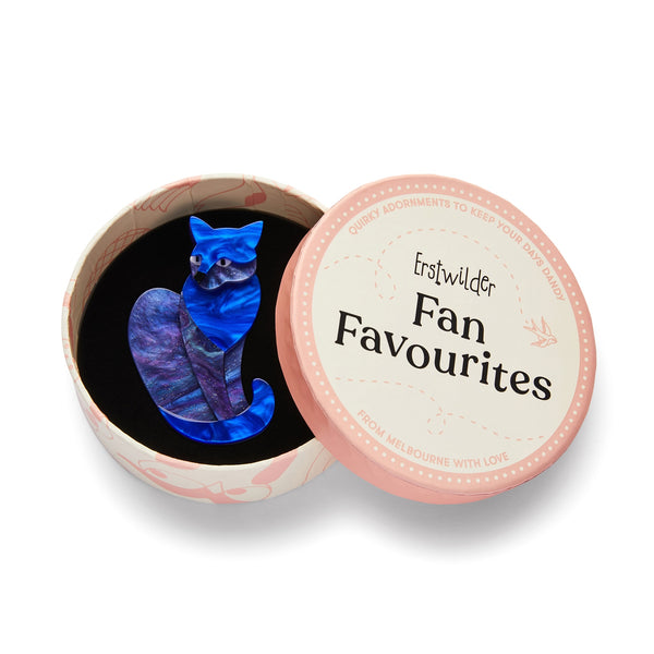 "Claudette" blue layered resin sitting cat brooch, shown in illustrated round box packaging