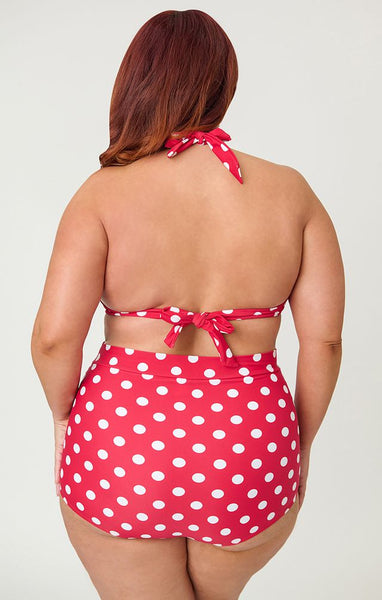 Bright red and polka dot patterned 50s style high-waist ruched front swim bottoms, shown on plus size model from back