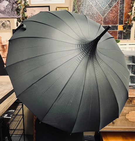 Black pagoda style umbrella, shown open from 3/4 top view