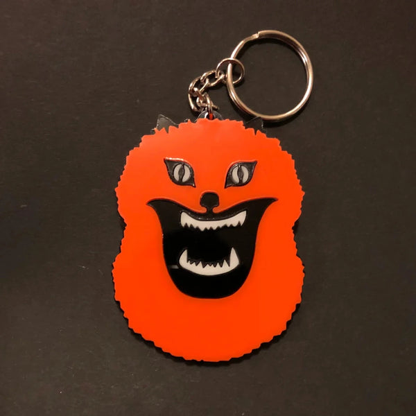 An acrylic keychain of a cat from the 1977 horror comedy movie Hausu
