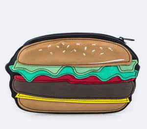 Zippered vinyl pouch in the shape of a cheeseburger with sewn pieces of faux leather in the shape of a bun, lettuce, cheese, burger patty and condiments. It has a black metal zipper along the top