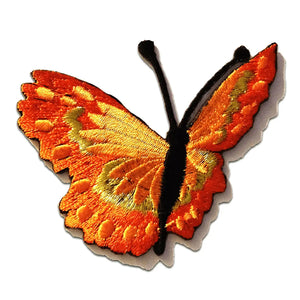 An embroidered patch of a butterfly with bright orange & yellowish orange wings. There is gold detail in the wings as well