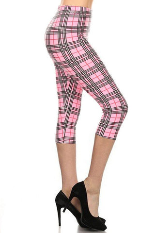 pink background plaid with red and black stretch knit high-waist capri length leggings, shown side view on model