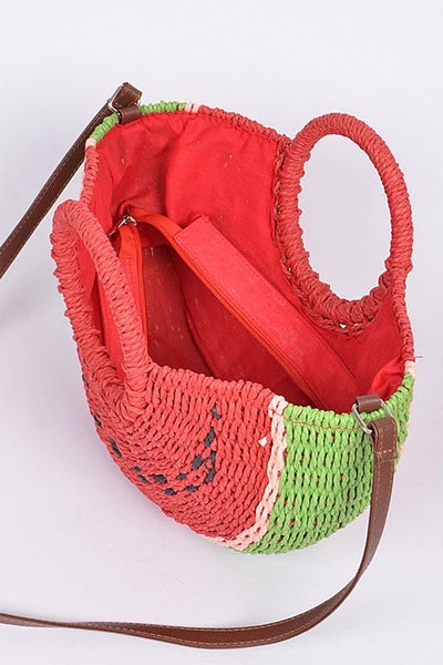 red, green, and black half-round watermelon slice shaped woven paper purse lined in red fabric, with wrapped circular handles and brown faux leather shoulder strap