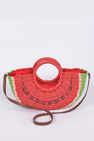 red, green, and black half-round watermelon slice shaped woven paper purse lined in red fabric, with wrapped circular handles and brown faux leather shoulder strap