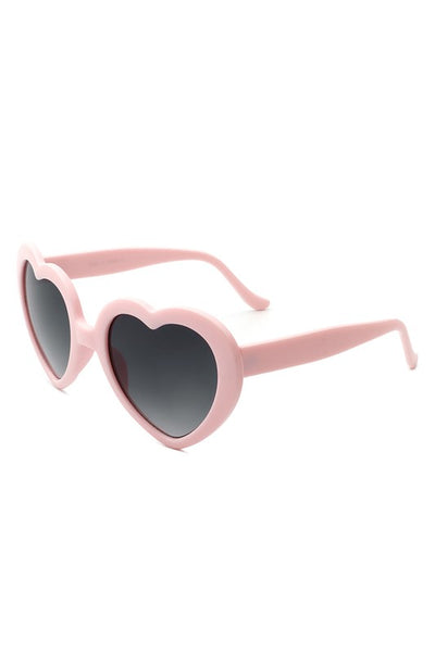 Pale pink plastic frame heart-shaped sunglasses with gradient smoke lenses, shown 3/4 view