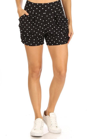 black with white polka dot print brushed fiber knit relaxed fit high waist shorts with elastic waist band, pleated front, ruched side seam detail, and pockets, shown on model