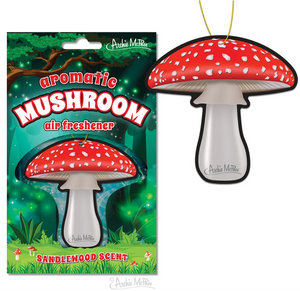 white and red heavy cardtock toadstool mushroom shaped air freshener, shown next to one in illustrated woodland scene backer card packaging