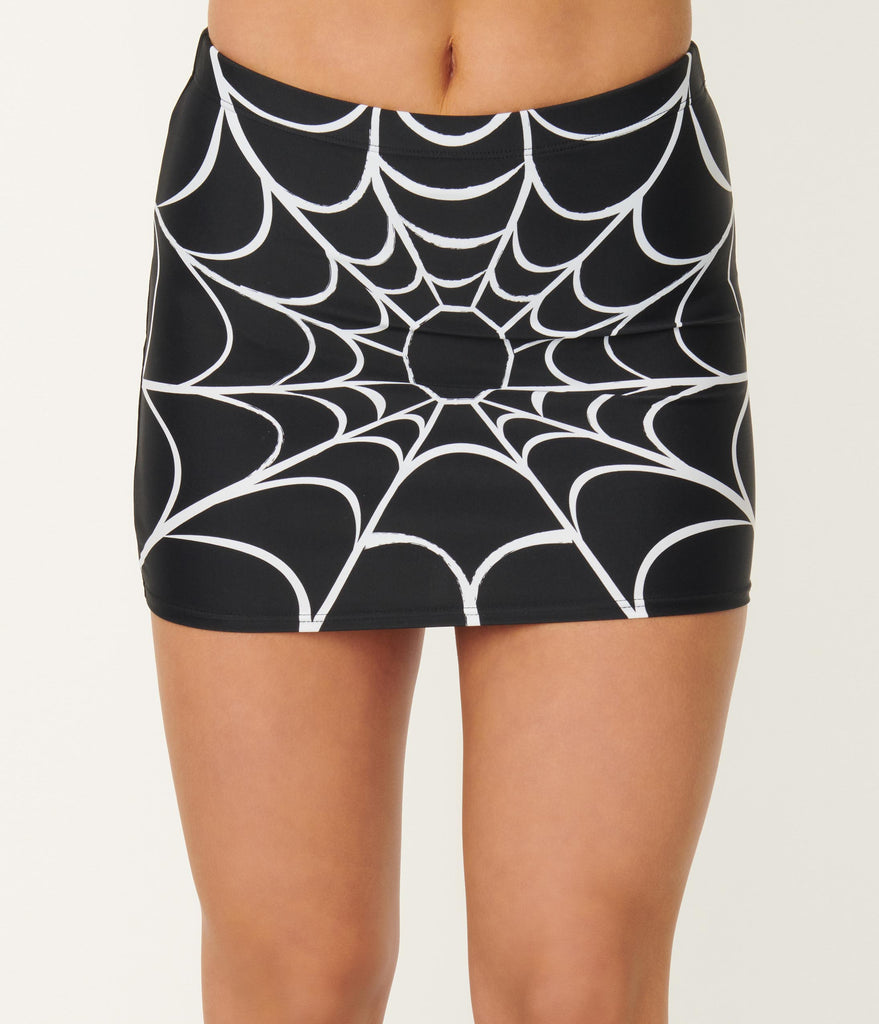 black with white spiderweb print high waist swim skirt, shown on model