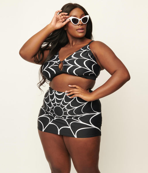 black with white spiderweb print swim top and high waist swim skirt, shown on model