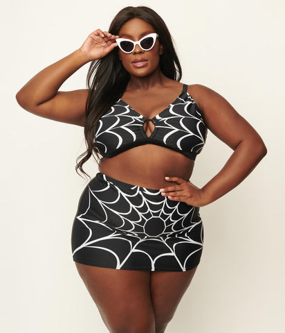 black with white spiderweb print swim top and high waist swim skirt, shown on model