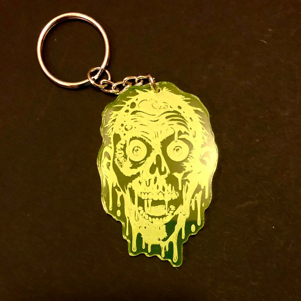 A neon green etched acrylic keychain of the Tarman from Return of the Living Dead