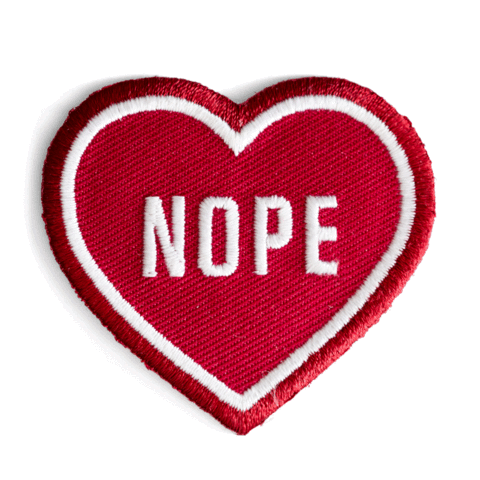 "NOPE" text in white on red heart embroidered patch