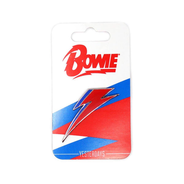 red and blue enameled silver metal David Bowie Aladdin Sane lightning bolt logo lapel pin, shown on illustrated cardstock backer packaging