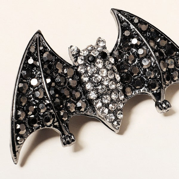 2 5/8" gunmetal finish bat-shaped barrette encrusted with black and clear faceted "rhinestone" jewels on sturdy 2" long pinch release clip fastener