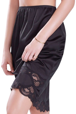 black elasticized waist knee length half slip featuring a pretty black lace hem, shown on model