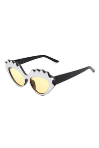 sturdy cat eye black plastic frames with bold "carved" upper eyelashes detail in metallic silver and yellow lens