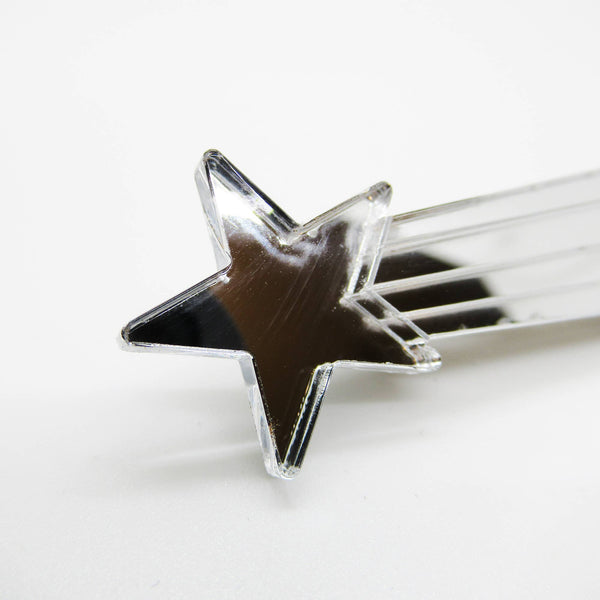 Shiny mirrored silver laser-cut acrylic 3" x 7/8" shooting star hair clip, shown close up 