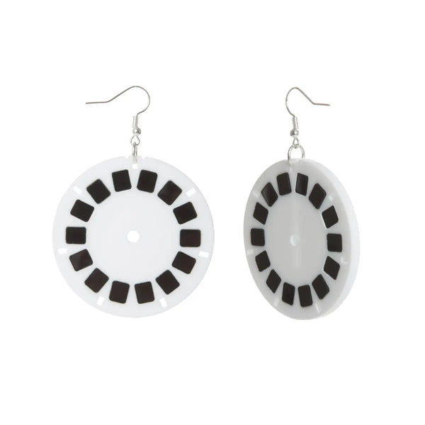 A pair of laser cut acrylic earrings in the shape of black and white view finder slides. With silver plated fishhook hardware. Shown at a 3/4 angle to display earring thickness