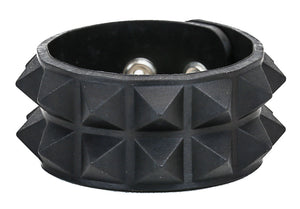A molded rubber bracelet with two rows of black rubber pyramid studs and double silver metal snap enclosures 